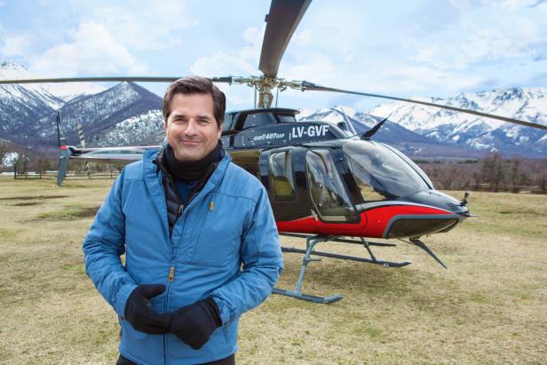 BAGUALES, PATAGONIA, ARGENTINA -SEPTEMBER 11 2017: Host Don Wildman  pauses next to his helicopter as he examins the October 1972 crash of the plane carrying an Uruguayan Rugby team in the Andes mountains during the filming of "Mysteries at the Museum Special: ALIVE". After a visit to the Andes Tragedy and Miracle Museum in Montevideo, Uruguay, Don Wildman learns firsthand what it took for the crash's sixteen survivors to overcome avalanches, sub-zero temperatures, and lack of food at 12.000 feet, and the devastating news that the search for them had been called off, as described in survivor Nando Parrado's book "Miracle in the Andes" (photo Gilles Mingasson for The Travel Channel).